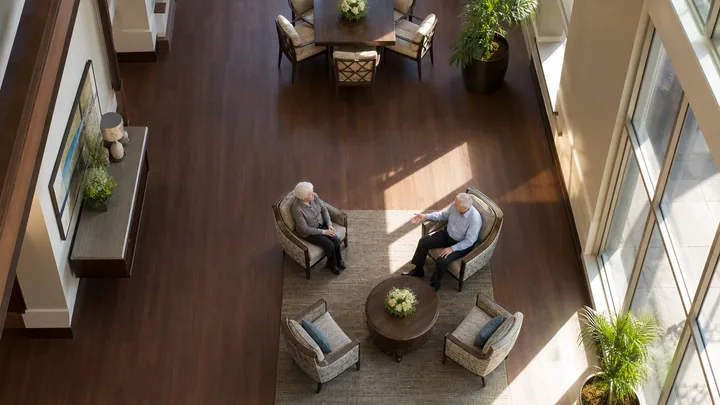 Overhead view of a tidy corridor lined with seating in morning light